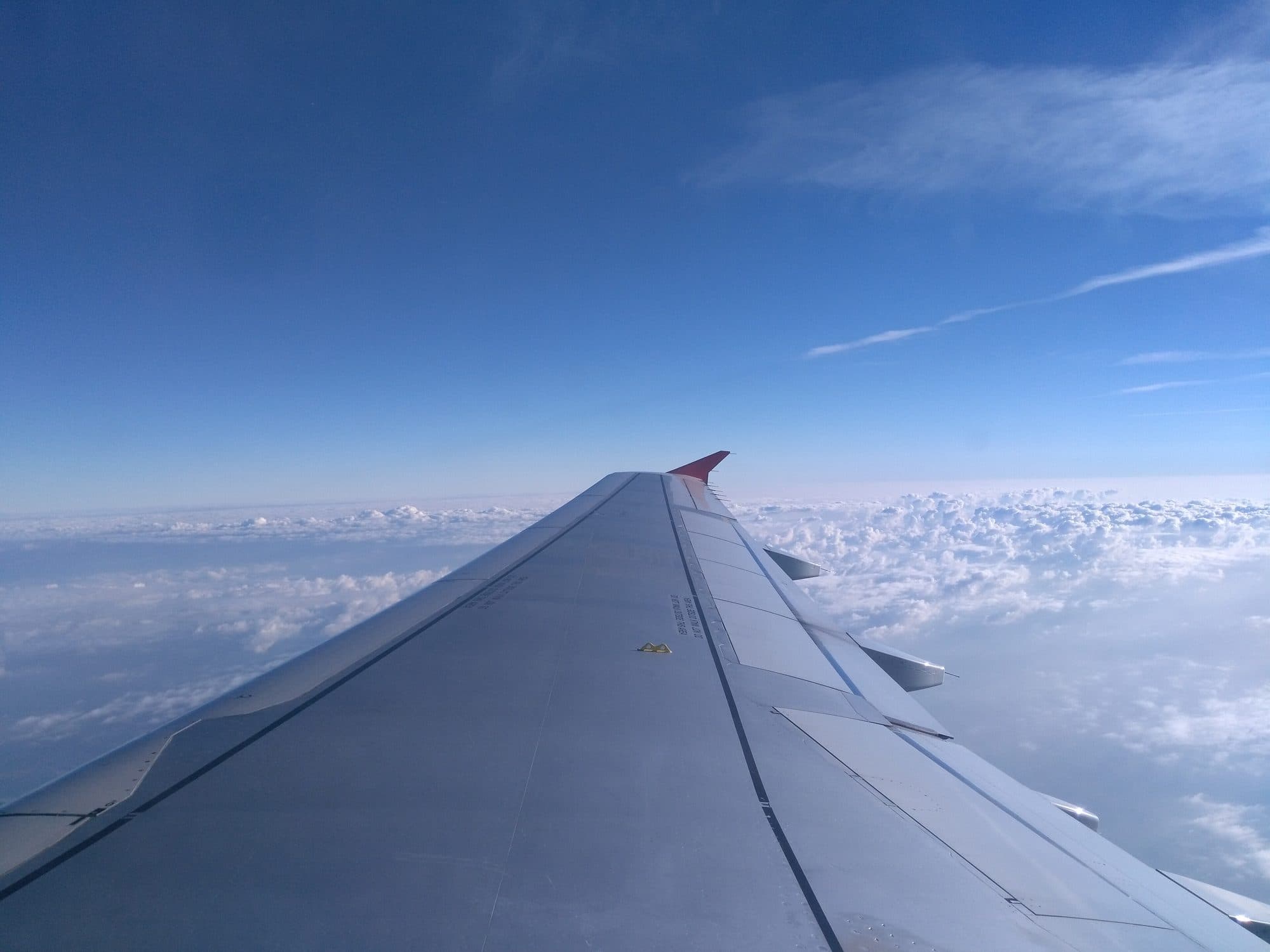 View from an aircraft window above the clouds